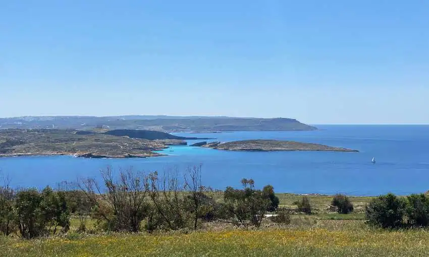 A breathtaking panoramic view from Qala Belvedere overlooking the deep blue channel towards the island of Comino and the Blue Lagoon.